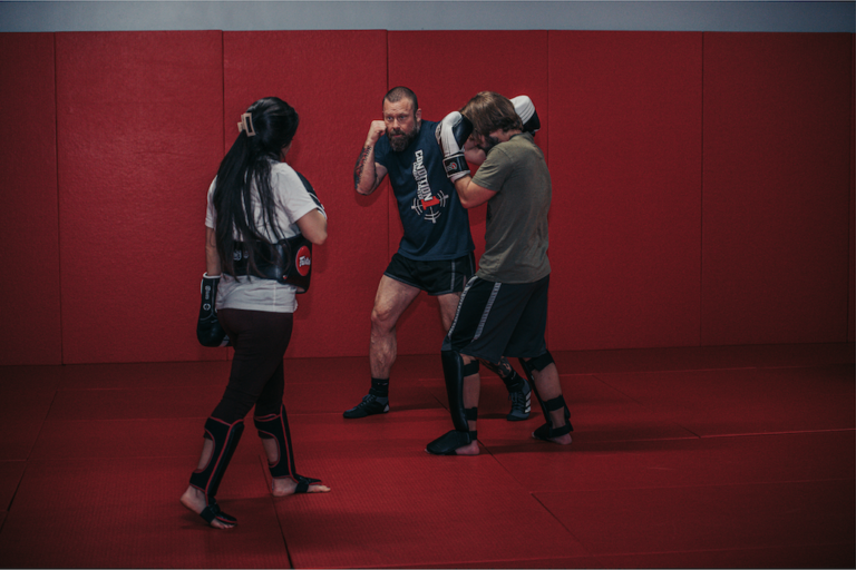 a group of people in a Kickboxing ring